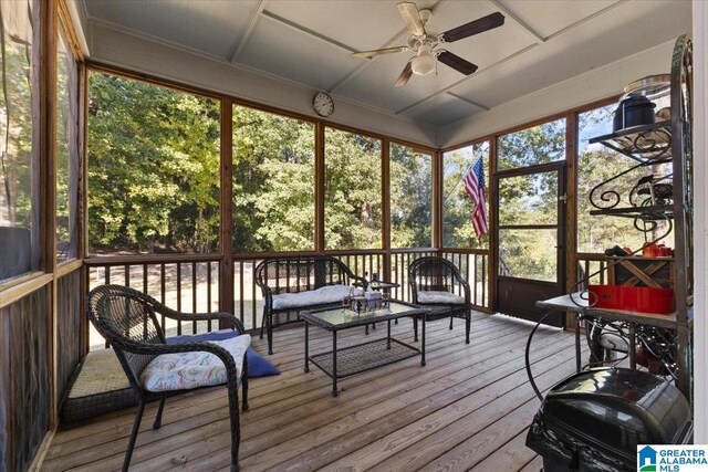 sunroom / solarium with a healthy amount of sunlight and ceiling fan