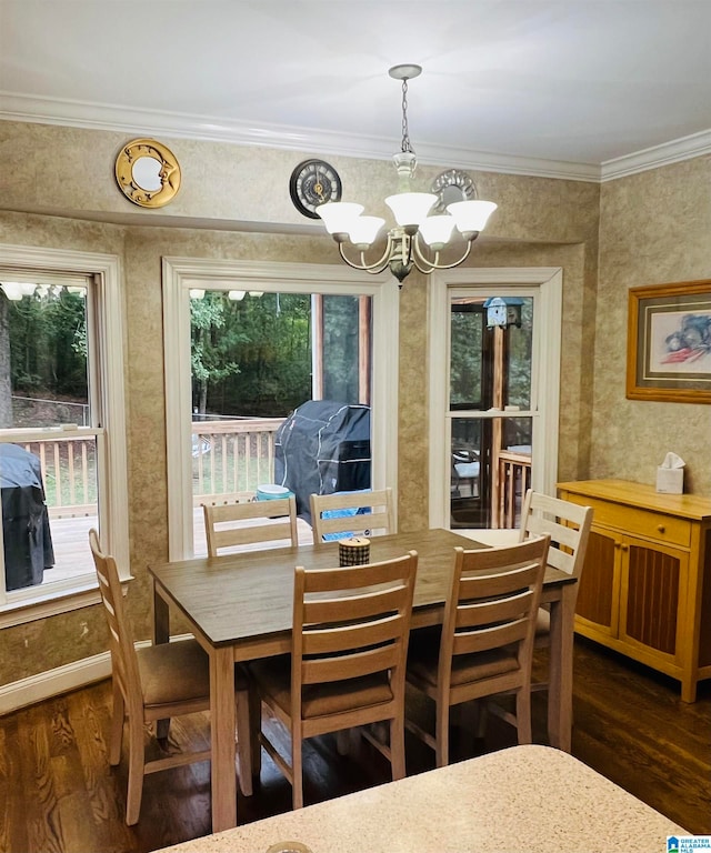 dining space with a notable chandelier, ornamental molding, and dark hardwood / wood-style flooring