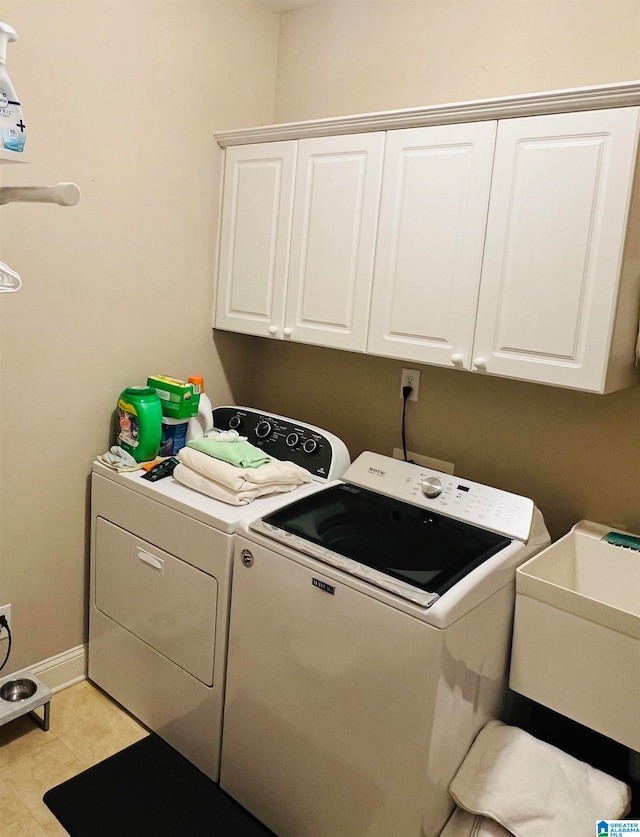 laundry room with sink, cabinets, and separate washer and dryer