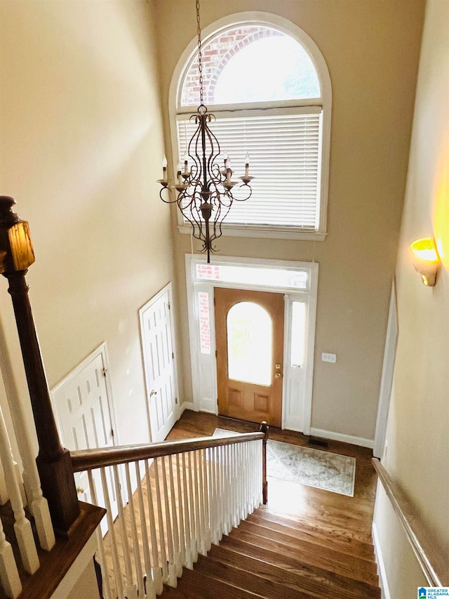 entrance foyer featuring a notable chandelier and dark hardwood / wood-style flooring