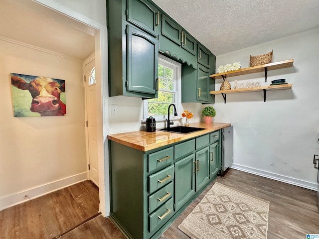 kitchen with green cabinetry, sink, dark hardwood / wood-style flooring, and butcher block counters