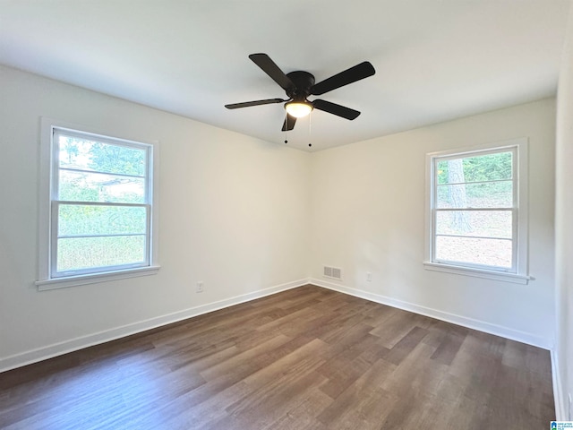 empty room with dark hardwood / wood-style flooring and ceiling fan