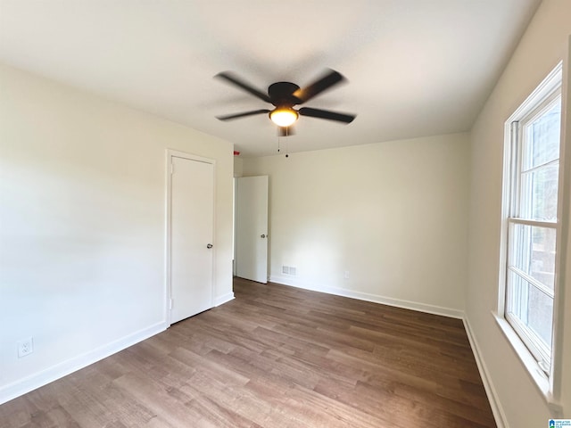 spare room featuring wood-type flooring and ceiling fan