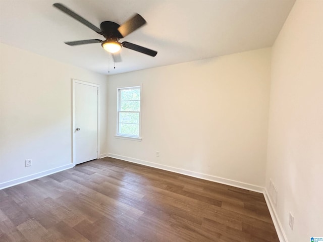 unfurnished room with ceiling fan and dark hardwood / wood-style flooring