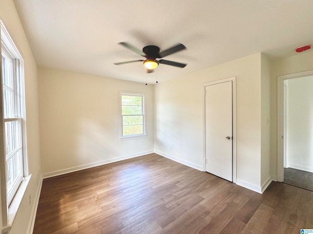 unfurnished bedroom featuring ceiling fan and dark wood-type flooring