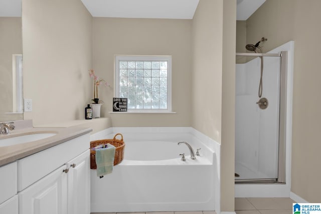 bathroom featuring tile patterned flooring, vanity, and separate shower and tub