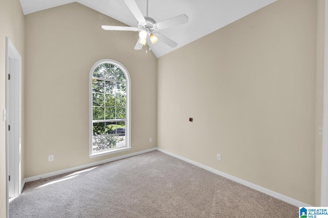 carpeted empty room with ceiling fan and lofted ceiling