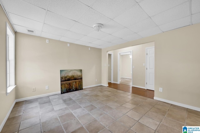 unfurnished living room with a paneled ceiling