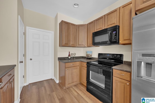 kitchen featuring black appliances and light hardwood / wood-style floors