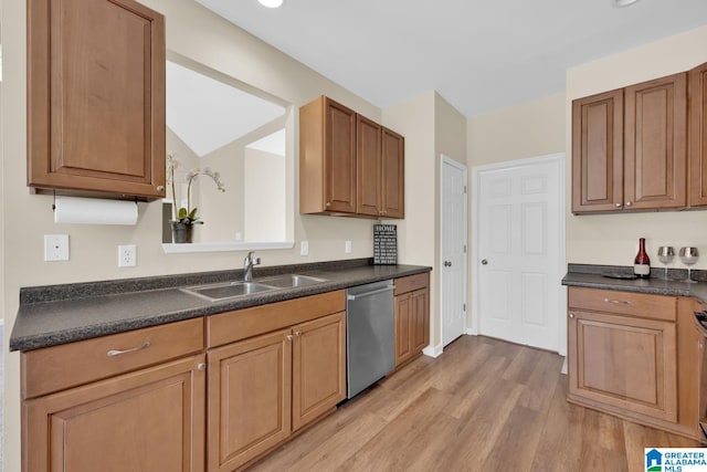 kitchen featuring light wood-type flooring, lofted ceiling, dishwasher, and sink