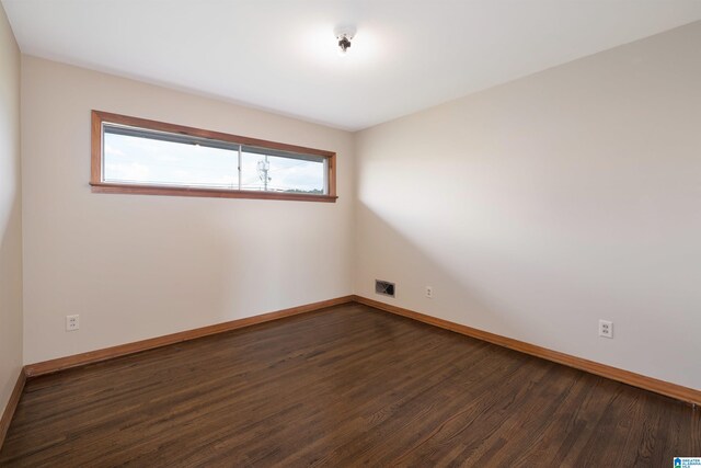 unfurnished room featuring dark hardwood / wood-style flooring