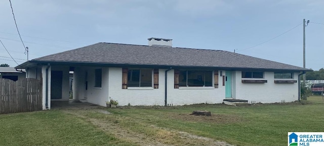 back of house featuring a yard