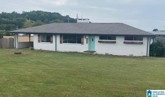 rear view of house with a lawn