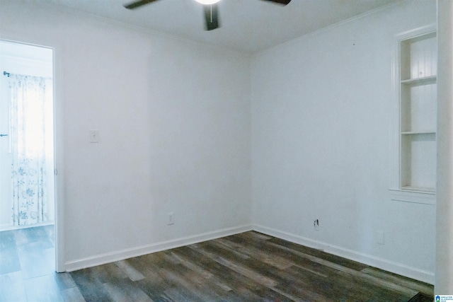 empty room featuring dark hardwood / wood-style flooring and ceiling fan