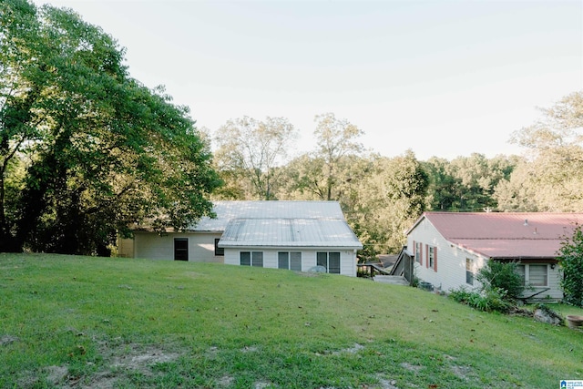 rear view of house featuring a yard