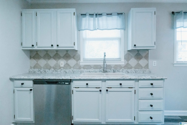 kitchen with backsplash, white cabinetry, dishwasher, and sink