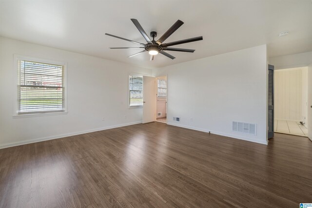 spare room featuring dark hardwood / wood-style flooring and ceiling fan