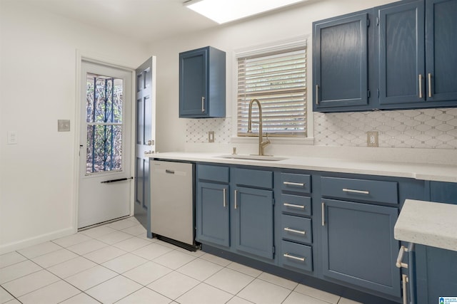 kitchen featuring blue cabinets, white dishwasher, plenty of natural light, and sink