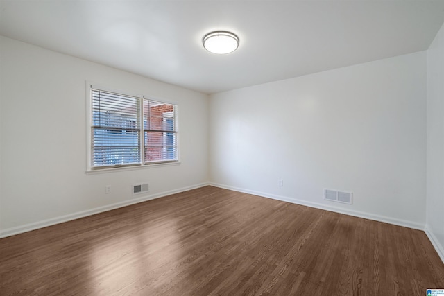 unfurnished room featuring dark hardwood / wood-style floors