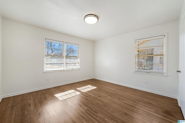 unfurnished room featuring dark hardwood / wood-style flooring