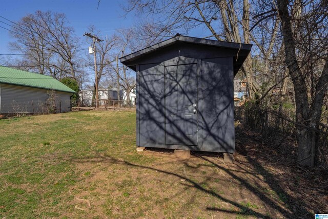 view of outdoor structure featuring a lawn