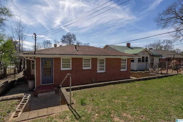 rear view of house featuring a yard