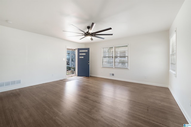 unfurnished room with dark hardwood / wood-style floors and ceiling fan