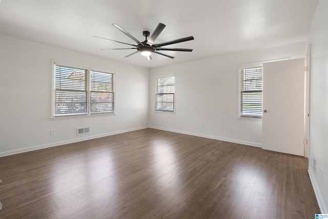 empty room with ceiling fan and dark wood-type flooring