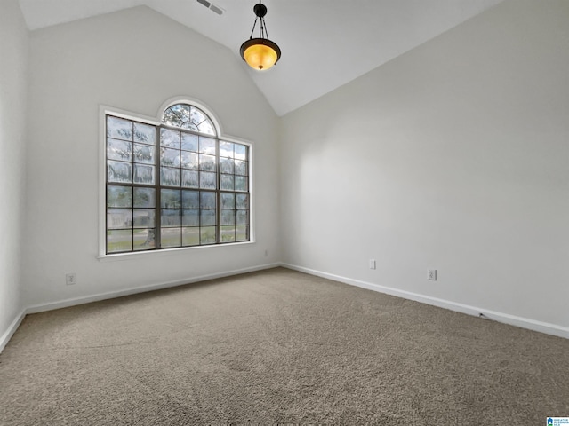 spare room with lofted ceiling and carpet flooring