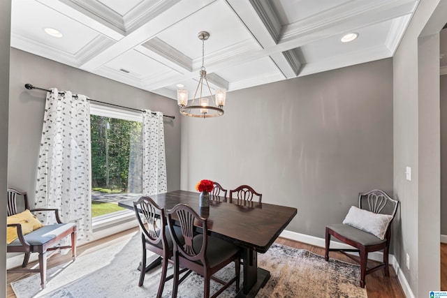 dining space featuring coffered ceiling, crown molding, beam ceiling, hardwood / wood-style floors, and a notable chandelier