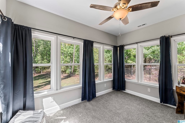 interior space featuring ceiling fan and carpet