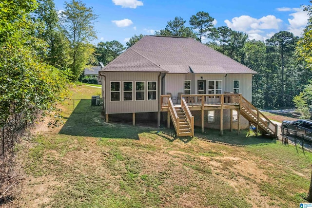 back of property featuring a lawn and a deck