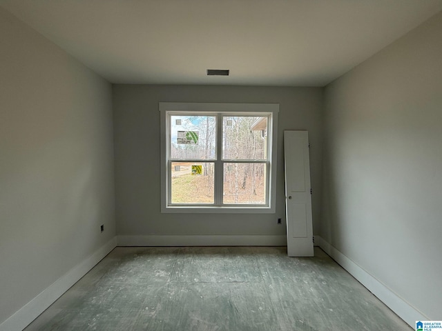 spare room with baseboards and visible vents