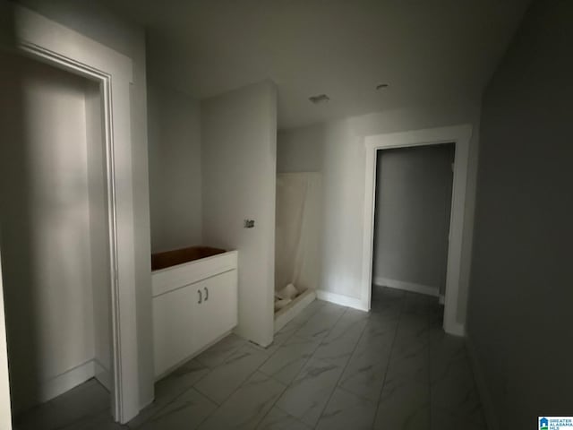 full bathroom with walk in shower, baseboards, and marble finish floor