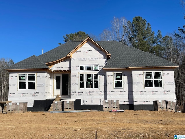 property under construction featuring roof with shingles