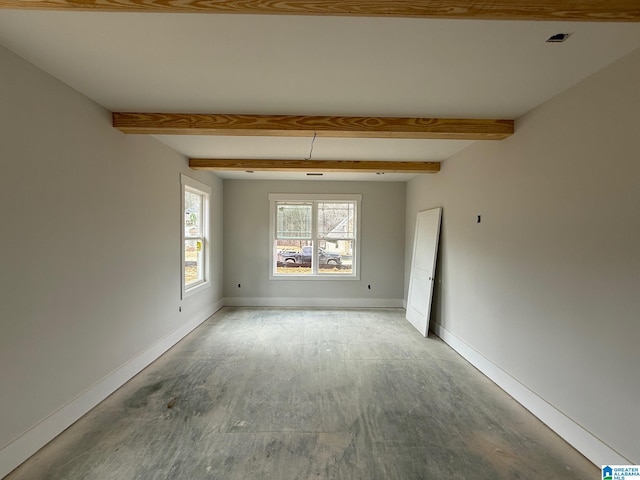 unfurnished room with beamed ceiling, wood finished floors, and baseboards