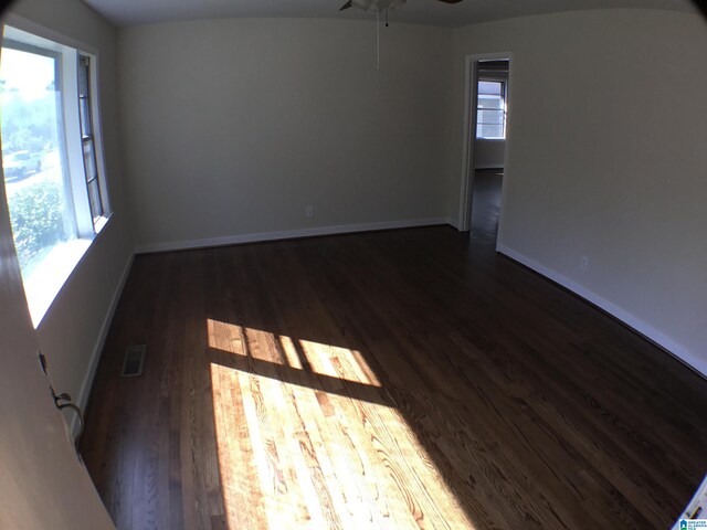 spare room featuring dark wood-type flooring and ceiling fan