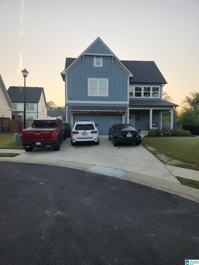 view of front of property featuring a yard and a garage