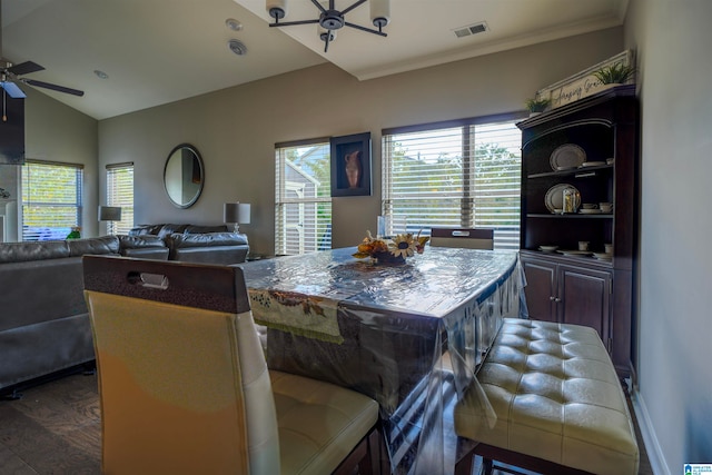 dining room with ceiling fan, crown molding, lofted ceiling, and dark hardwood / wood-style flooring