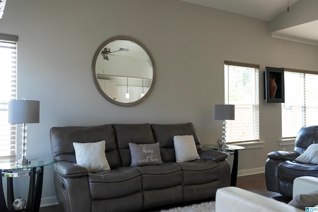 living room featuring a healthy amount of sunlight, hardwood / wood-style flooring, ceiling fan, and vaulted ceiling