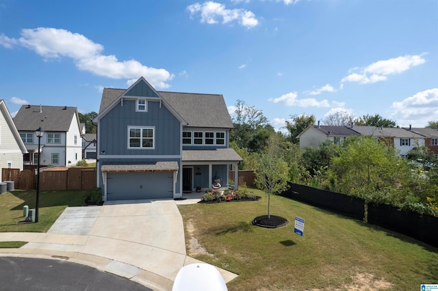 view of front of property with a front yard and a garage