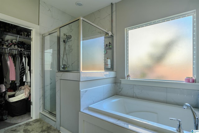 617 Windmill Cir, Helena, AL 35080 - bathroom featuring a stall shower, a bath, and a spacious closet