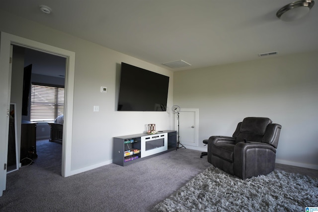 living room with dark carpet