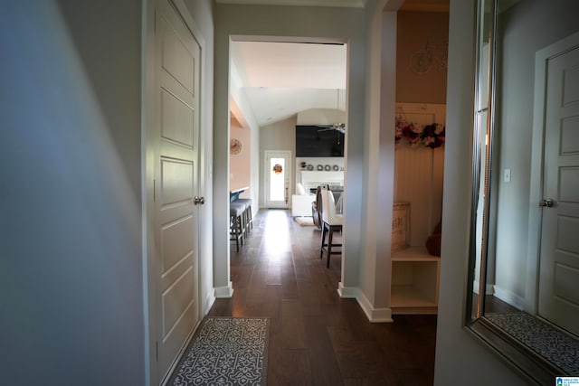 hallway featuring dark hardwood / wood-style flooring and vaulted ceiling