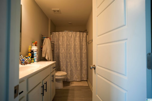 bathroom with vanity, toilet, hardwood / wood-style flooring, and a shower with shower curtain