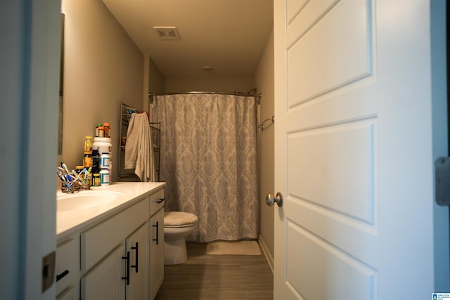 617 Windmill Cir, Helena, AL 35080 - full bath with toilet, vanity, a shower with shower curtain, and wood finished floors