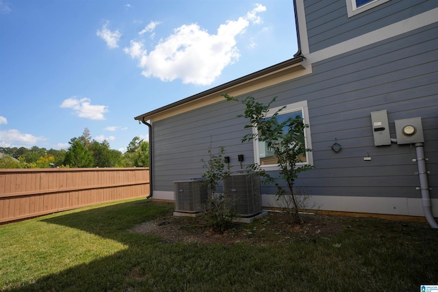 view of home's exterior with a yard and central air condition unit