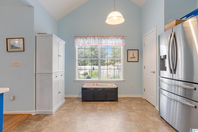 kitchen with stainless steel refrigerator with ice dispenser, high vaulted ceiling, and white cabinetry