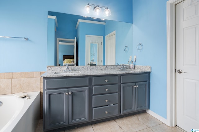 bathroom featuring vanity, tile patterned floors, and a bathtub