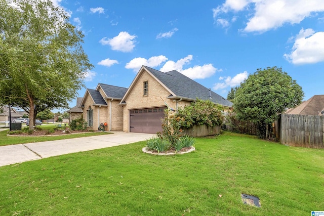 view of front of property featuring a garage and a front yard